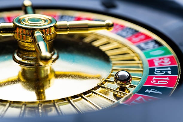 Overhead view of live roulette wheel with ball landing in red number 7
